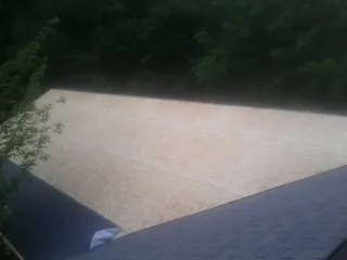 New OSB roof sheathing installed beside an existing shingle roof in Bossier City